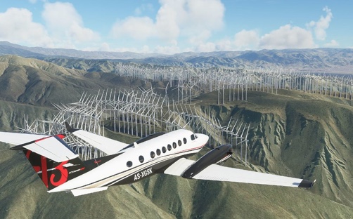 A Beechcraft 350 King Air flying over Palm Springs wind farm